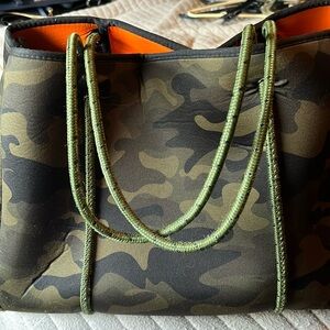 Camo bag with wristlet, pop of orange inside for fun, by Haute Shore